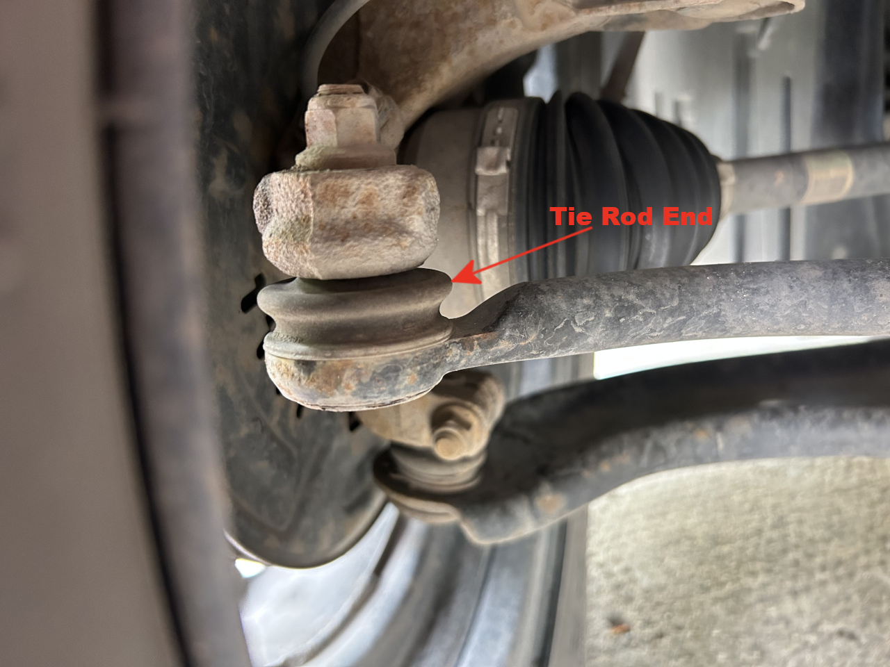A Picture of a car’s tie rod end and boot.
